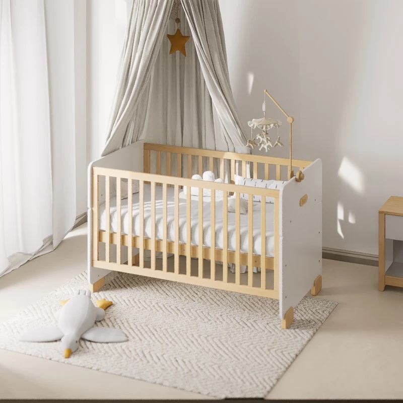 White and natural-wood convertible cot bed in a nursery, with a canopy and a hanging mobile above it White and natural-wood convertible cot bed in a nursery, with a canopy and a hanging mobile above it